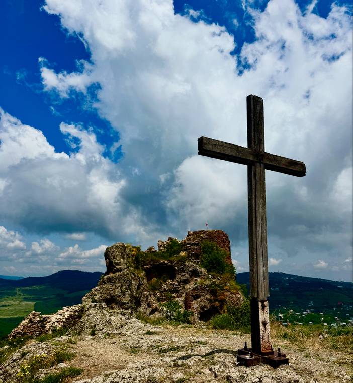 A wooden cross on a rocky hilltop above Tbilisi, Georgia